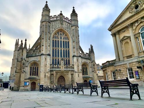 a group of benches in front of a building at Little Elm - luxury home from home, free parking, 30-40 mins walk from Bath city centre in Bath