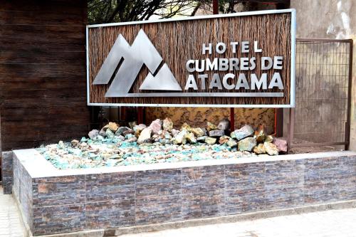 a sign for a hotel with a pile of rocks at Hotel Cumbres de Atacama in Copiapó