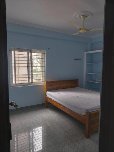 a bedroom with a bed in a blue room at FEEL LIKE HOME near Cricket stadium in Visakhapatnam