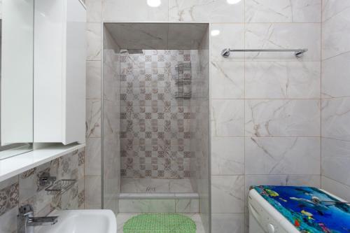 a bathroom with a shower with a toilet and a sink at BEST CHOICE in Old Tbilisi City Center in Tbilisi City