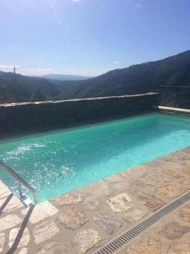 a swimming pool with a view of the water at MAISON DE CHARME EN ARDECHE DU SUD AVEC PISCINE in Beaumont