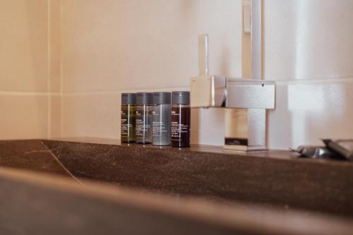 a bathroom counter with bottles of cosmetics on it at Alpe d'Huez Houses - Les Balcons du Golf in L'Alpe-d'Huez