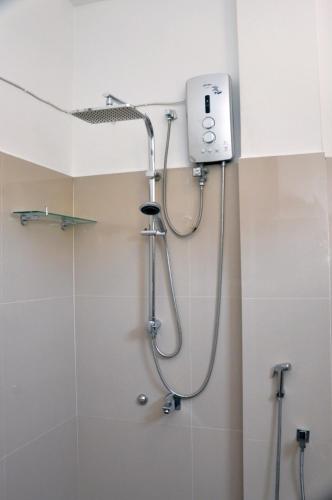 a shower in a bathroom with a shower head at The Ocean in Galle