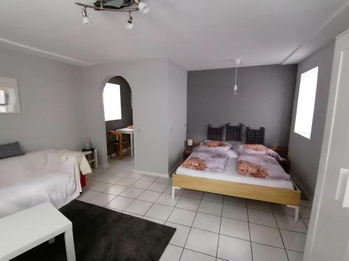 a bedroom with two beds in a room with a window at Ferienwohnung Dillamar in Veitshöchheim