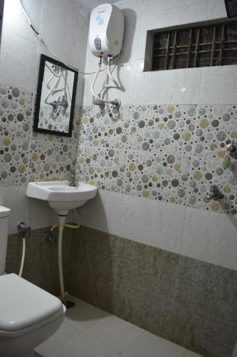 a bathroom with a toilet and a sink at Thakur Boutique Hotel in Udaipur