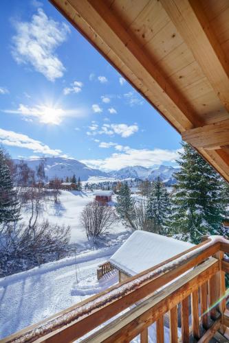 a view from the deck of a cabin in the snow at Alpe d'Huez Houses - Les Balcons du Golf in L'Alpe-d'Huez