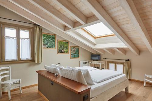 a bedroom with a large bed and a skylight at Agriturismo Alba Del Borgo in Fidenza