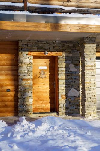 a wooden door on the side of a building at Alpe d'Huez Houses - Les Balcons du Golf in L'Alpe-d'Huez
