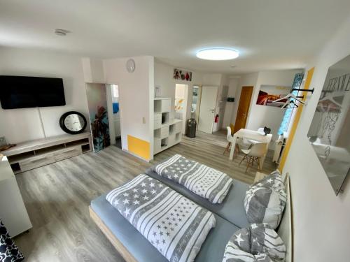 een slaapkamer met 2 bedden en een woonkamer bij Apartment 2P. Balkon Zentral 1.4 in Bad Sooden-Allendorf