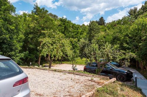 two cars parked in a parking lot with trees at Garmen Hills Guest Houses in Garmen