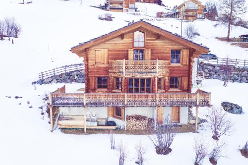 HérémenceにあるLe CHEMOの雪上の丸太小屋の空中風景