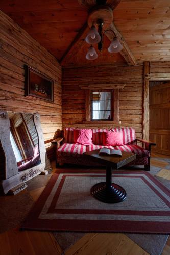a living room with a couch and a table at Hotel Villa Rina in Bormio