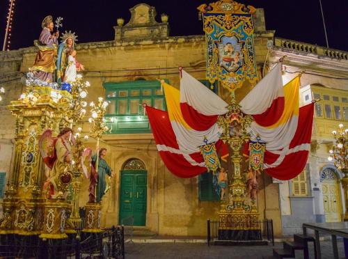 a building with a flag in front of it at B&S Accommodation Renovated 18 Century House of Character Ghaxaq, Malta in Hal Ghaxiak