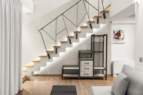 a staircase in a living room with black and white stairs at ATHENIAN VIEW LOFT in Athens