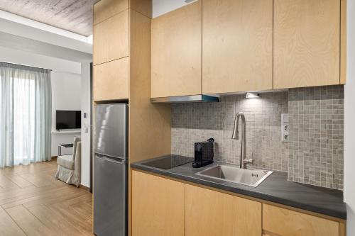 a kitchen with a sink and a refrigerator at ATHENIAN VIEW LOFT in Athens