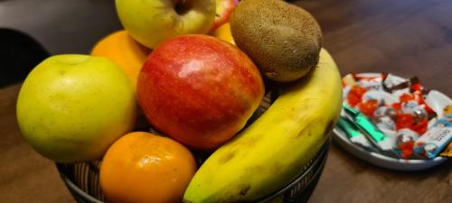 a bowl of fruit on a wooden table at סוויטת נור Noor Suite in Majdal Shams