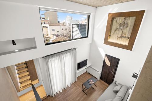 a living room with a large window and a couch at ATHENIAN VIEW LOFT in Athens