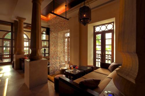 a living room filled with furniture and a large window at Grand Hyatt Goa in Bambolim