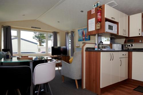 a kitchen with a counter and a table with chairs at Captain's Quarters in Brixham