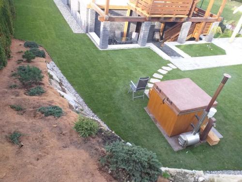 an aerial view of a yard with a table and a chair at Apartmánový Dom Terchová in Terchová