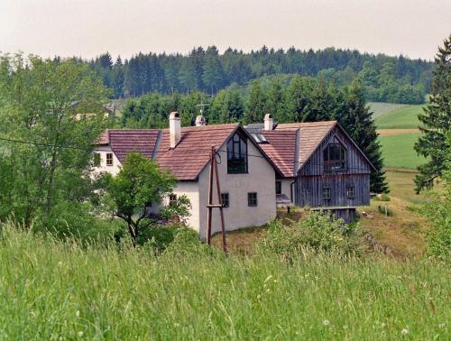 a large white house in a field of grass at WALD-LAND-HOF Schloss Rosenau in Schloss Rosenau