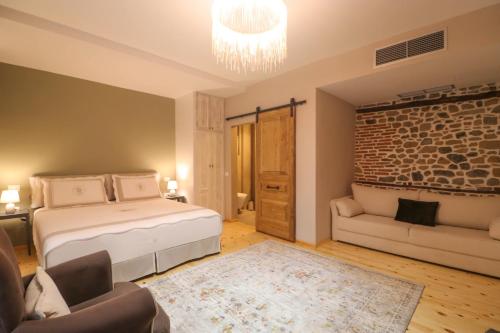 a bedroom with a bed and a couch in a room at Në Kroi in Korçë
