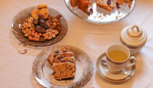 a table with two plates of food and a cup of coffee at Në Kroi in Korçë