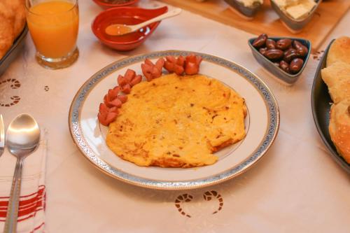 a table with a plate of food on a table at Në Kroi in Korçë