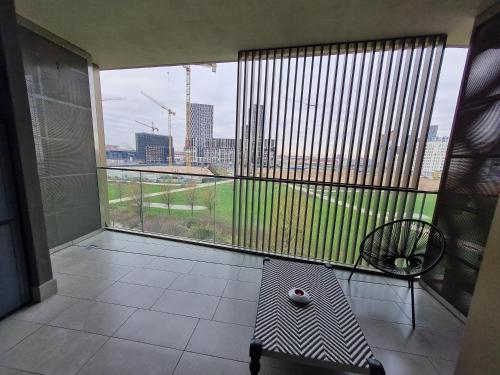 a balcony with a large window with a view of a city at Grazioso Monolocale Milano in Milan