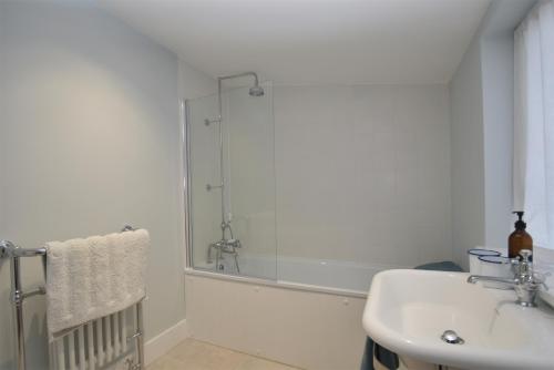 a bathroom with a shower and a sink at Seaside Retreat in Rye Harbour
