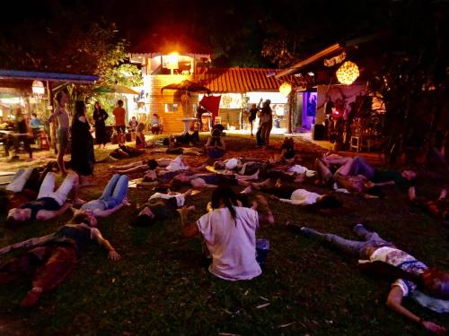 a group of people laying on the grass at night at Good Life Dacha Wellness Homestay in Pai