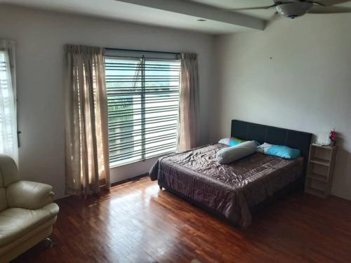 a bedroom with a bed and a large window at 7eVenKitchen Hmestay in Jitra