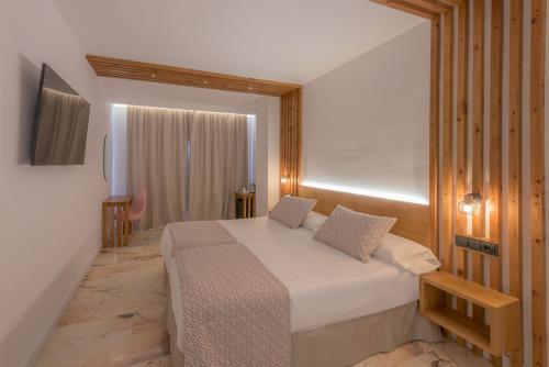 a bedroom with a large bed in a room at Hotel Boutique Sibarys - Adults Recommended in Nerja