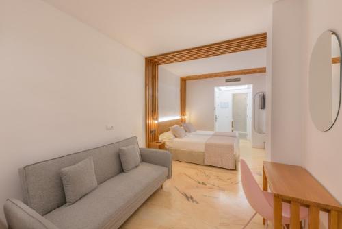 a living room with a couch and a bed at Hotel Boutique Sibarys - Adults Recommended in Nerja