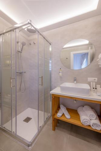 a bathroom with a shower and a sink and a mirror at Hotel Boutique Sibarys - Adults Recommended in Nerja
