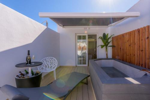 a hot tub in a room with a table and a chair at Hotel Boutique Sibarys - Adults Recommended in Nerja