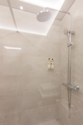a bathroom with a shower with a glass door at Hotel Boutique Sibarys - Adults Recommended in Nerja