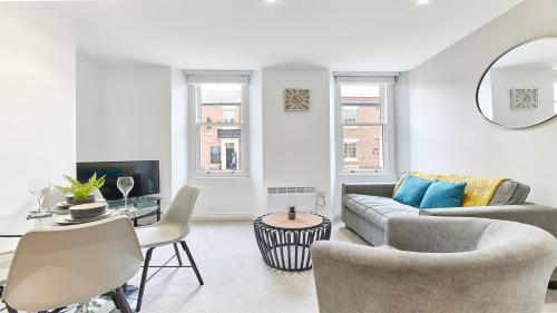 a living room with a couch and a table at Roker boutique apartment in Sunderland