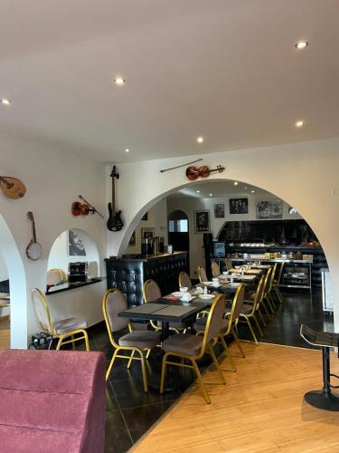 a dining room with a long table and chairs at Le moulin in Pornic