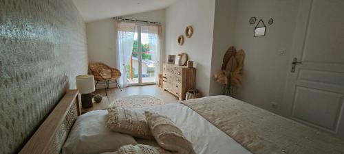 1 dormitorio con 1 cama y puerta a una habitación en La Cabane Bohème, Maison d'hôtes Bassin d'Arcachon, en Gujan-Mestras