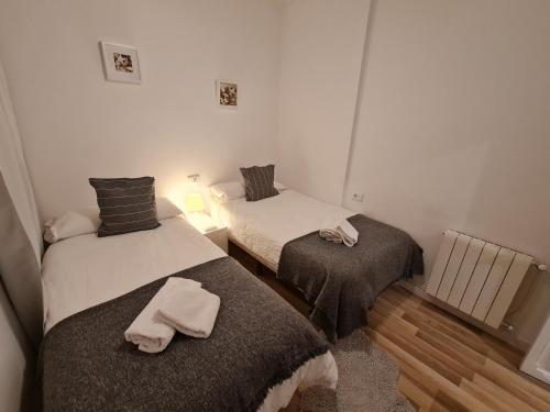 a room with two beds with towels on them at Alojamientos Segóbriga Rural (Artesa) in Segorbe