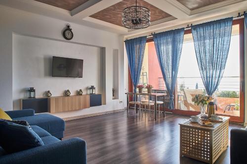 a living room with a blue couch and a table at Familiya Apartments in Gurzuf