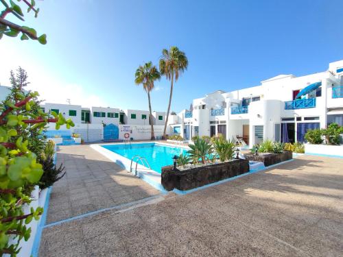 a view of a swimming pool in front of a building at BLU in Puerto del Carmen