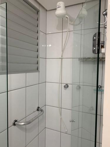 a bathroom with a shower with a glass door at Apartamento no Aguas da Serra TOP in Rio Quente