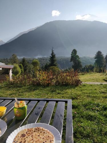 a table with a plate of food on top of it at Bente's Lodge in Pahalgām