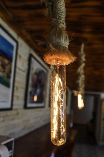 a mason jar with lights in it hanging from a ceiling at Pousada Capitólio in Capitólio