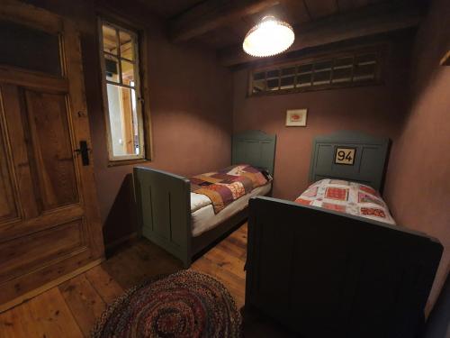 a small room with a bed and a window at Scheune 27 Krebsow in Krebsow