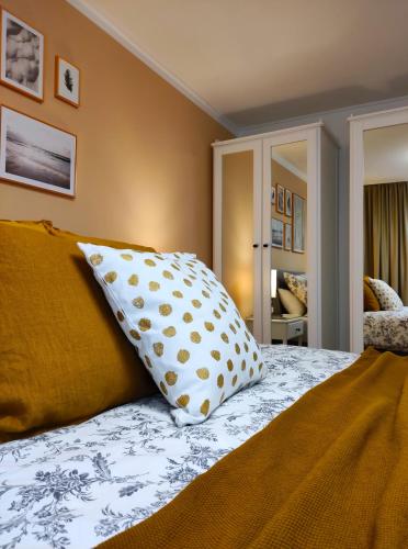 a bedroom with a bed with two pillows on it at Appartement RügenZeit in Lancken-Granitz