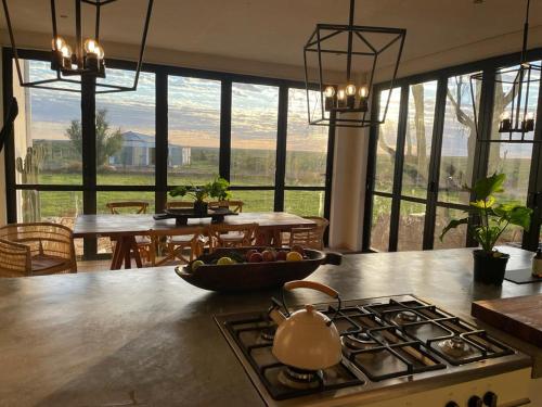 a kitchen with a stove and a table with a tea kettle at Britskraal Guest Farm in Strydenburg