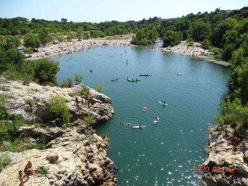 a group of people swimming in a lake at Proche Pézénas, très bel appartement, commerces in Pézenas